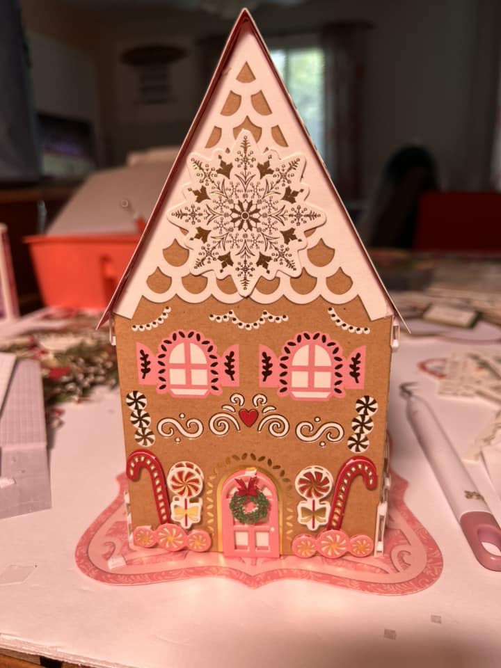 A gingerbread house is sitting on top of a table.