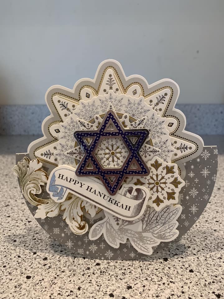 A happy hanukkah card with a star of david.