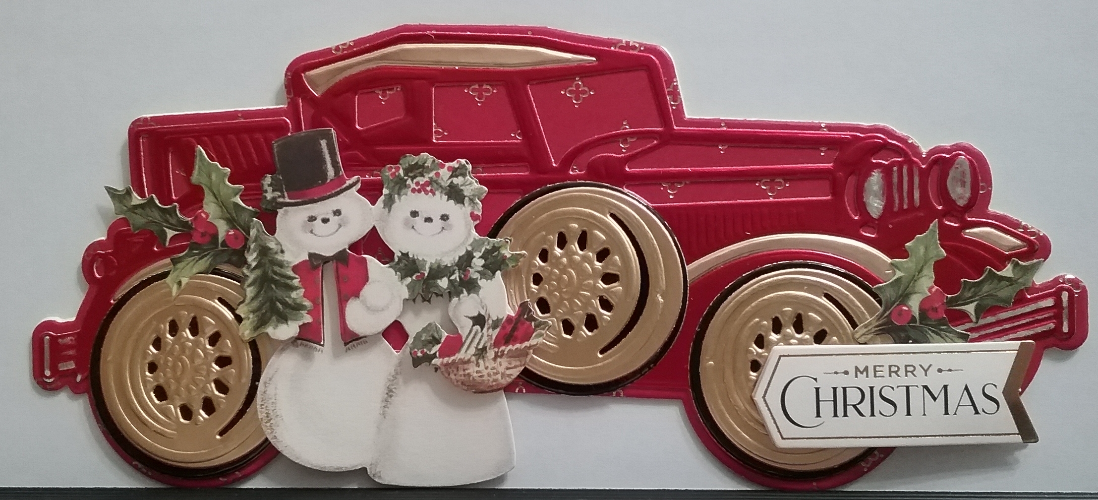 A christmas card with a snowman and a truck.
