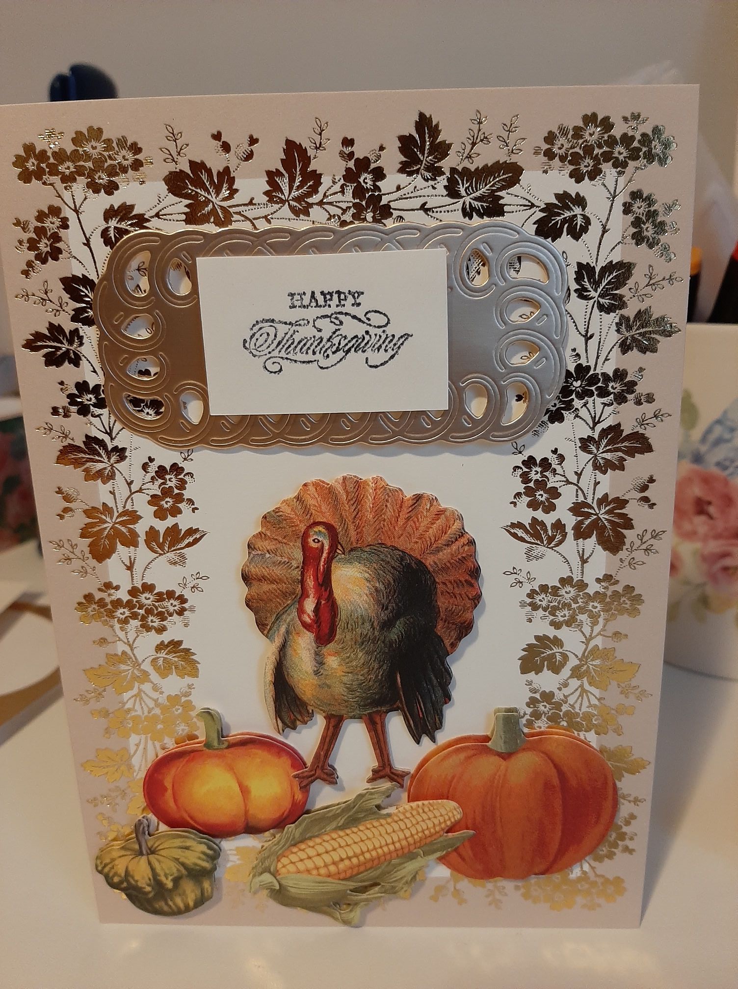 A thanksgiving card with a turkey and pumpkins.