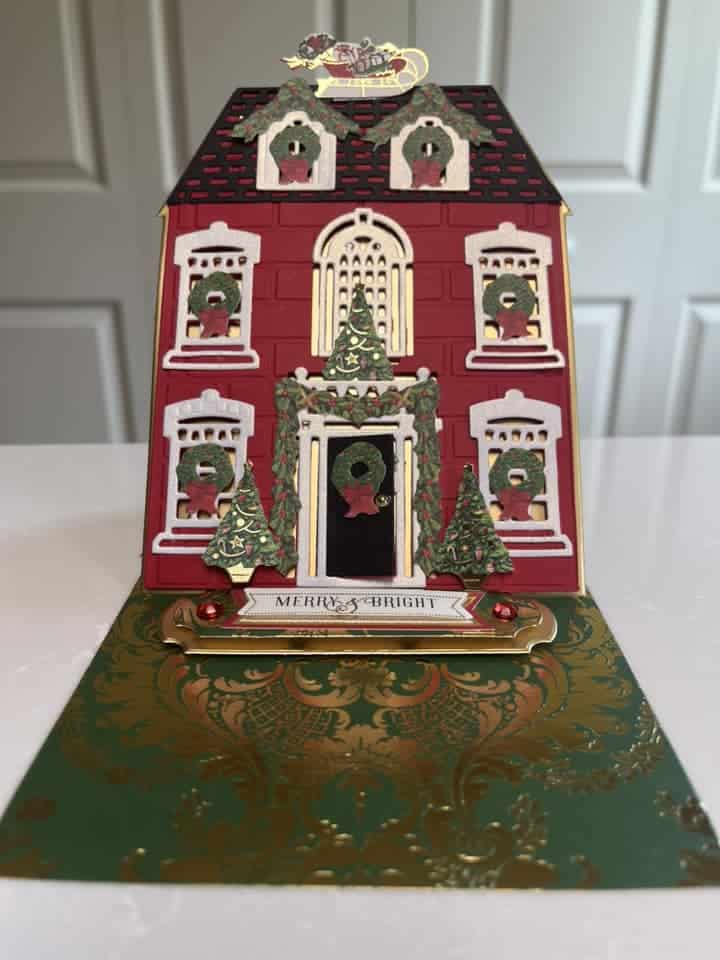 A christmas card with a house on it.