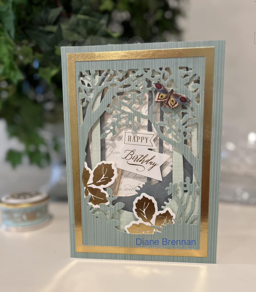 A birthday card with a tree in the background.