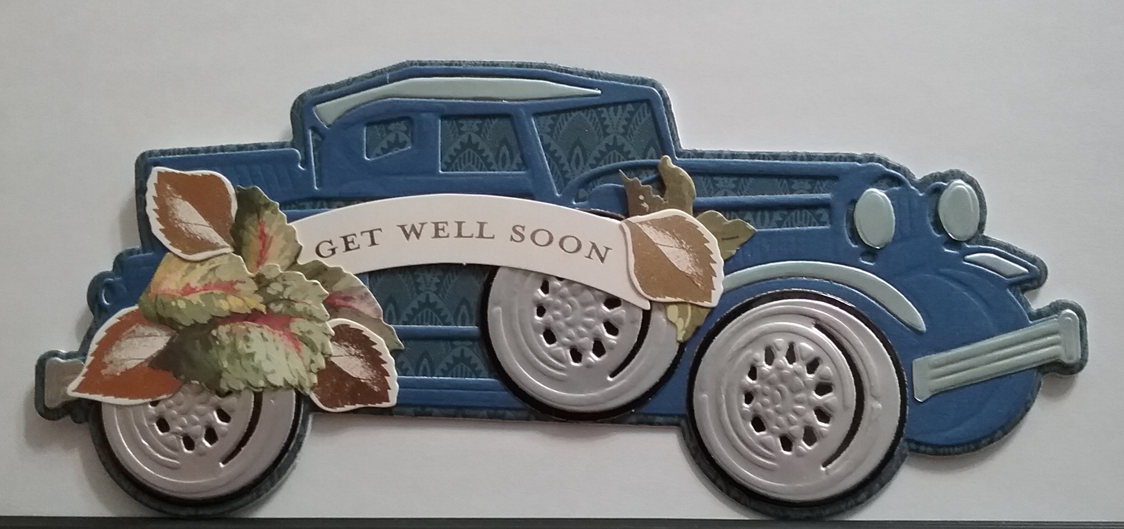 A blue car with the words get well soon on it.
