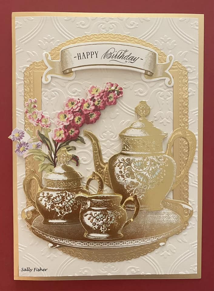 A card with a teapot and flowers on it.
