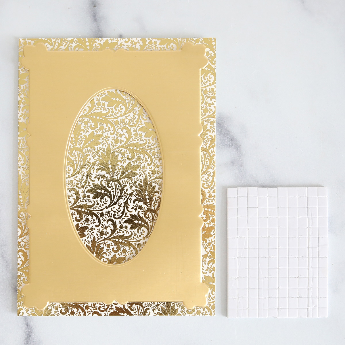 A gold foiled card with a white background.